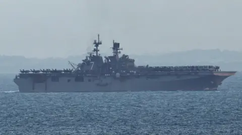 The USS Tripoli (LHA-7) amphibious assault ship enters the Singapore Strait