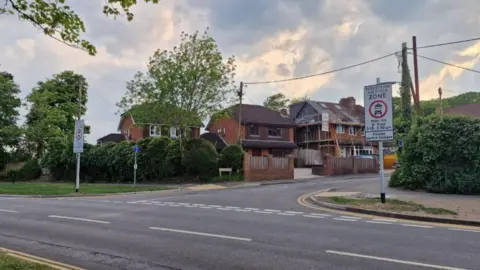 An image of Bullers Road which will be part of Surrey's first Safer Street scheme. The two pedestrian signs can be seen either side of the road's entrance.