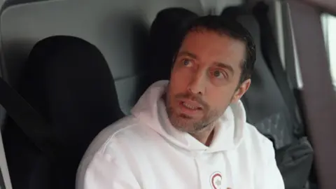 Peter North sat in his van