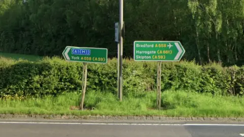 Road signs on a junction, showing the A658 linking York to Bradford.