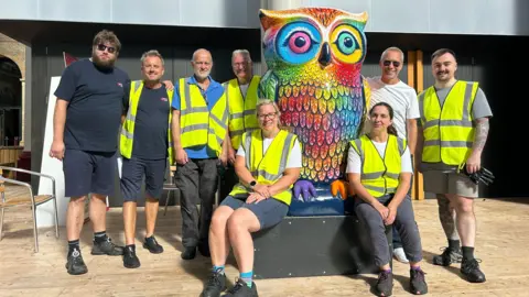 North London Hospice North London Hospice logistics partners PFE sit next to one of the owls on the trail