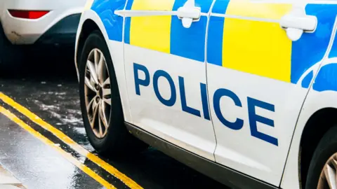 Police Scotland car parked behind another vehicle on a double yellow line