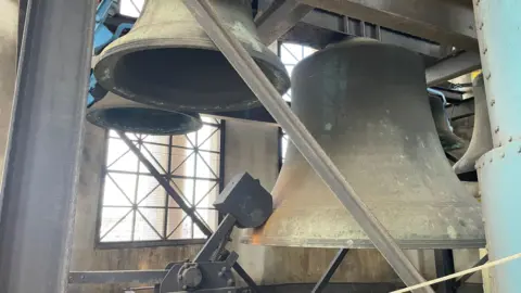 BBC Little John, with smaller bells, hanging in position under the dome of the Council House