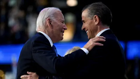 Reuters Joe and Hunter Biden looking at each other and smiling