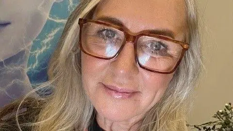 A selfie of Lynne Elms wearing glasses