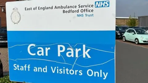 Steve Hubbard/BBC A large car park sign, in blue and white, in a car park in Bedford.