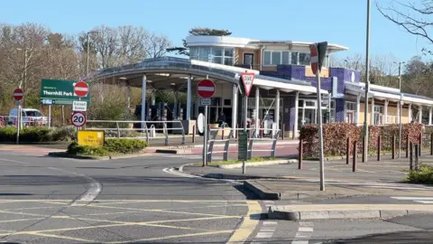 The car park at the park and ride, including the central building and bus stop.
