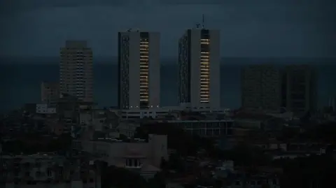 AFP A few buildings in the city with electricity are seen during a nationwide blackout caused by a grid failure in Havana on October 18, 2024 qhiqhhiqzridqqinv