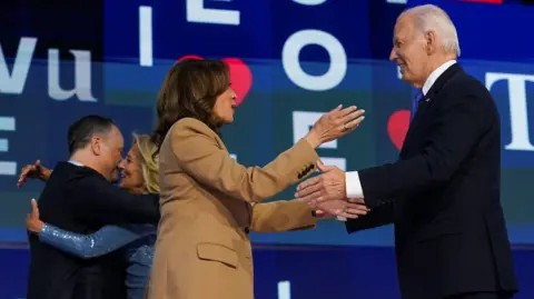 Reuters US Vice President Kamala Harris and President Joe Biden prepare to hug at the Democratic National Convention