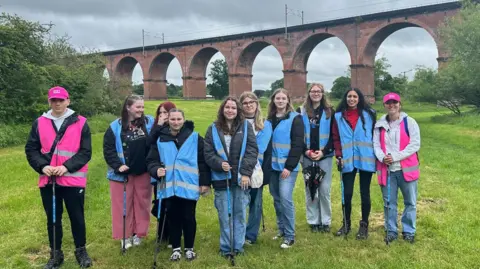A group of fans in front of Twemlow Viaducton the tour
