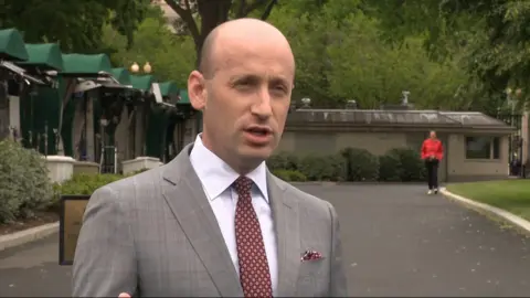 Stephen Miller, the White House deputy chief of staff wearing a suit and tie 