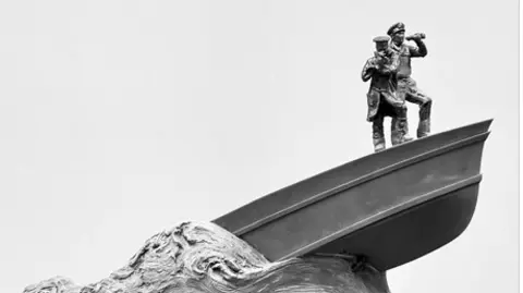 Coastal Forces Heritage Trust A boat on a wave is seen with two figures standing at the helm 
