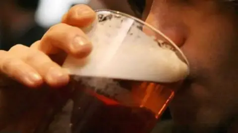 PA Media Person drinking pint 