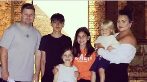 Family handout Josh and Chloe Bashford with their four young children all looking to camera