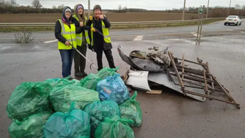 Mark Fishpool Litter picking group with bags of rubbish on the A47