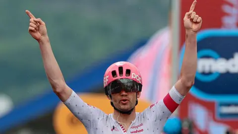 Kasper Asgreen with his arms aloft as he wins stage 14 of the 2025 Giro d'Italia