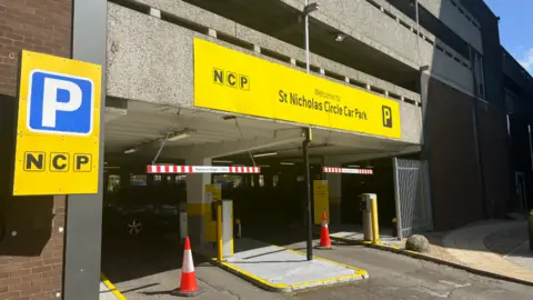 Traffic cones bar the entrance to an NCP car park 