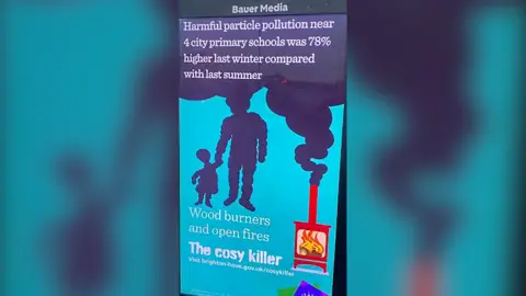A digital poster showing a graphic of a wood-burning stove that was emitting smoke in the shape of an adult and child