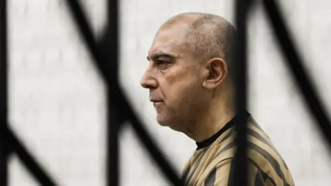 Atef Najib, former head of Political Security in Deraa under ousted president Bashar al-Assad, attends a trial session at the Palace of Justice, in Damascus, Syria (26 April 2026)