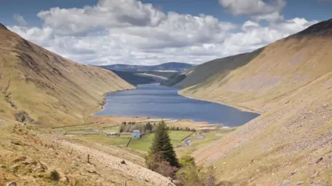 Getty Images A view down to the Talla Reservoir, a body of water surrounded by rugged countryside