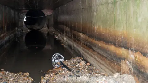 LDRS Dark and gloomy culvert which takes rainwater 