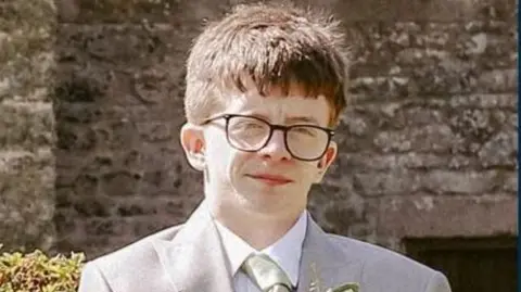 A man in glasses wearing a suit