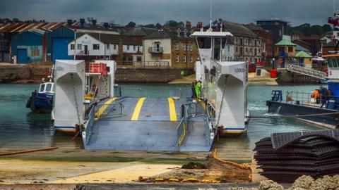 Slipway slping down to the ramp onto the chain ferry with the river in the background and the slipway at East Cowes