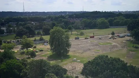 Protect Brockwell Park An aerial view of the land in the park after a festival, looking all muddy where grass should be. Plenty of trees surround the area and the rest of the park space looks green.