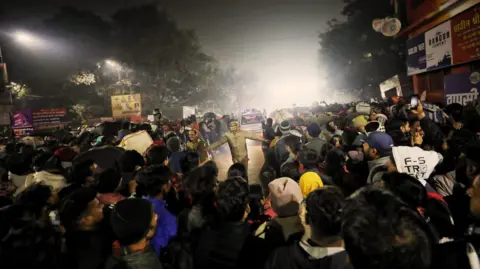 Ankit Srinivas A policeman clearing the road as an ambulance passes by after a deadly stampede before the second "Shahi Snan" (grand bath), at the "Kumbh Mela" or the Pitcher Festival, in Prayagraj, previously known as Allahabad, India, January 29, 2025.