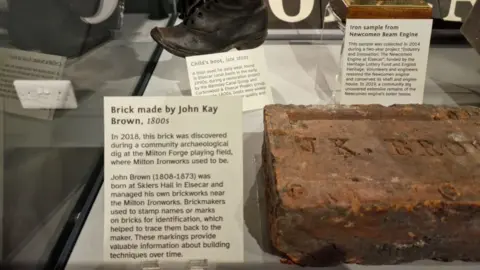 BBC/Mick Lunney A brick inside a display cabinet, it dates back to the 1800s and was made in Elsecar