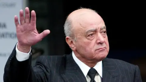 Reuters Mohamed Al Fayed holds up his hand