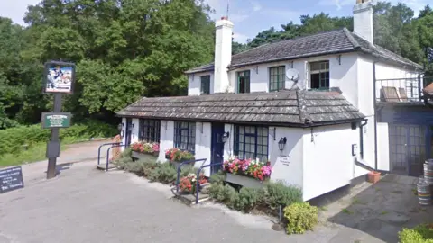 Local Democracy Reporting Service A white pub with two chimneys and dark grey tiles. 