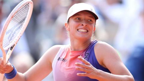 Iga Swiatek celebrates winning a point against Coco Gauff at the 2024 French Open