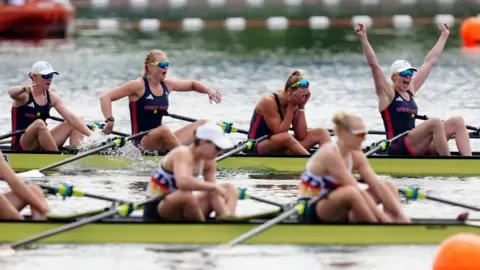 PA Media Four athletes react with shock and jubilation, while another team in the foreground are more subdued