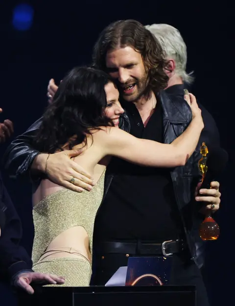 Reuters Joff Oddie and Ellie Rowsell of Wolf Alice embrace, as they receive an award for Group of the Year during the BRIT Awards at the Co-op Live Arena, in Manchester, Britain, February 28, 2026. REUTERS/Isabel Infantes
