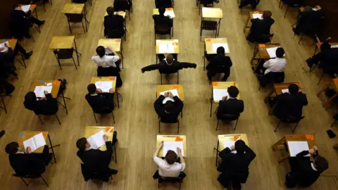 PA Media Aerial shot of rows of students taking an exam