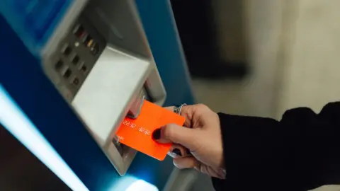 Getty Images A generic image of a bank card being inserted into a payment machine