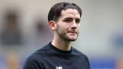York City's Ricky Aguiar looks pensive in a warm-up top