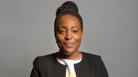 House of Commons A portrait image of MP Taiwo Owatemi - her hair is tied up and she is wearing a white top and a black jacket.