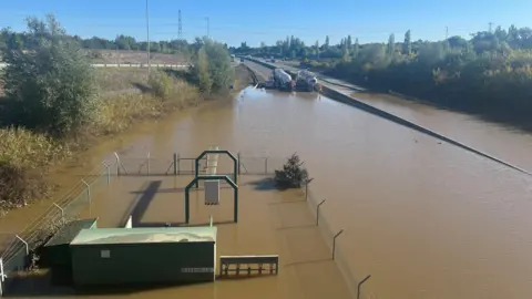 Flood water on the A421 at Marston Moretaine has receded so you can now see the pumping station and a car which had both been under water