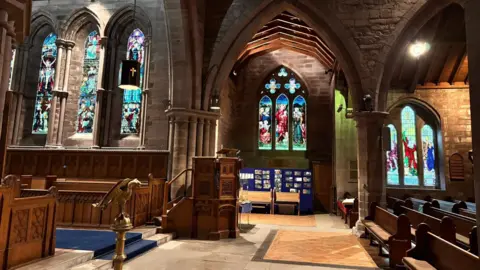 Brechin Cathedral Trust The interior of Brechin Cathedral, with a pulpit, pews and stained-glass windows