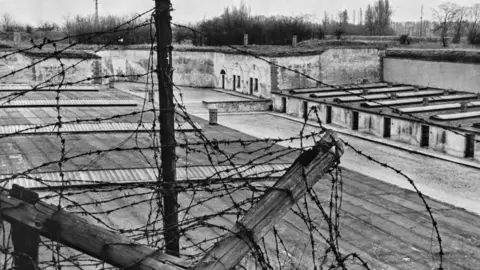 Getty Images A high-angle view through barbed wire of the fourth courtyard at the Theresienstadt Ghetto, in the fortress town of Terezín, German-occupied Czechoslovakia (Protectorate of Bohemia and Moravia), 1945.