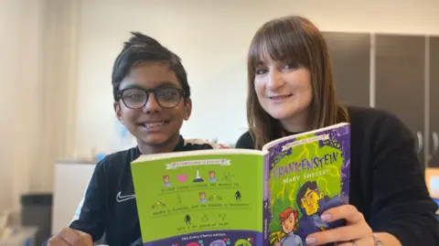 BBC Child and adult reading a book