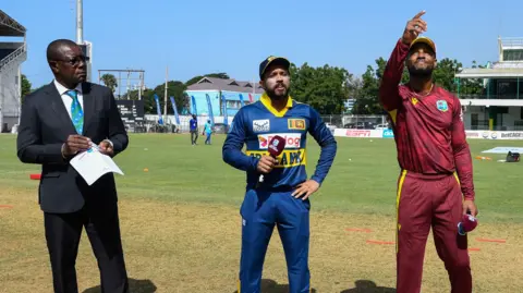 Sri Lanka captain Kusal Mendis and West Indies skipper Shai Hope toss up, watched by match referee Sir Richie Richardson