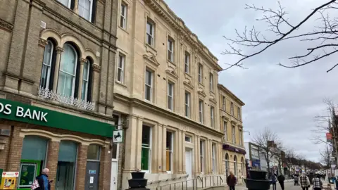 GUY CAMPBELL/BBC The stone facade of the former Post Office building in Lowestoft 