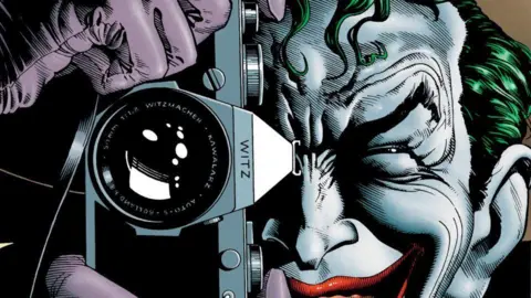 DC Comics The Joker holding a camera to his face 