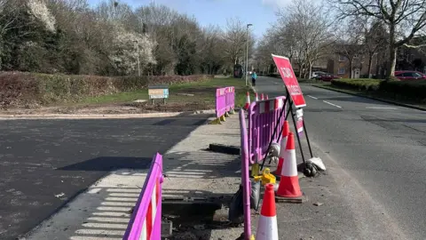 Kirsty Knight A road closed using purple barriers and a red sign reading "Road Closed". 