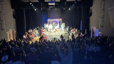 Emma Meek Wrestling fans cheer on the competitors in the ring at the Deanery Theatre in Swindon