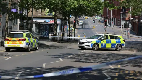 Nottinghamshire Police Police vehicles and cordons in Milton Street where the suspect had attempted to run over three people in a van, after fatally stabbing two teenage students and an older man on 13th June 2023.