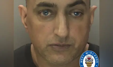 Habeeb Khan wearing a black top. He is looking straight at the camera and part of the West Midlands Police logo is visible.